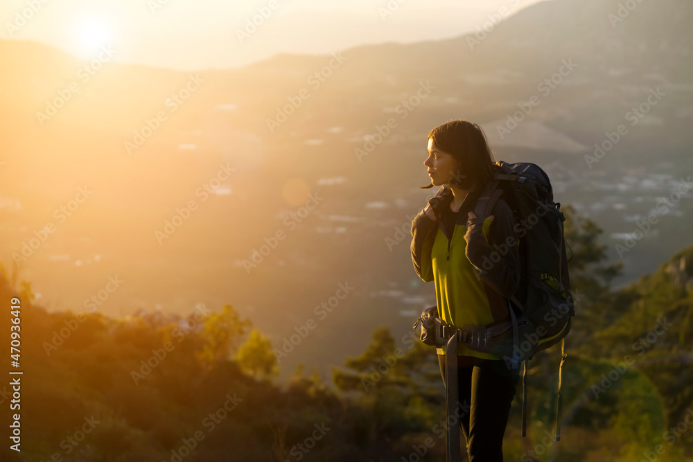 Fototapeta premium Happy girl is hiking in the mountains.