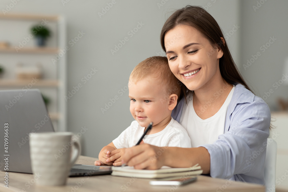 Online Education. Young Woman Holding Baby And Study With Laptop At Home Online Education. Young Woman Holding Baby And Study With Laptop At Home
