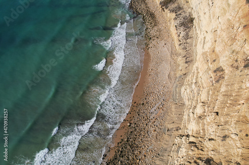 Beach and waves from top view. Turquoise water background. Summer seascape from air. Portugal Lagos Algarve. Travel concept and idea