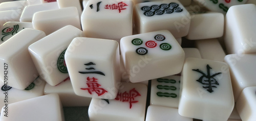 Mixed and scattered different mahjong tiles.