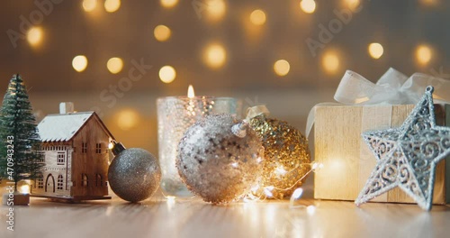 Christmas background with bright Christmas tree toys, beautiful bokeh, a toy house and candles. christmas holidays home cosiness concept