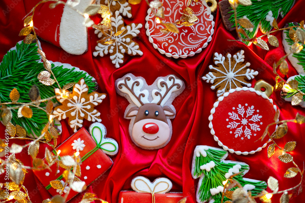 Banner for Christmas and New Year gingerbread cookies deer, Santa Claus, snowflakes, Christmas trees, garlands on red silk fabric background