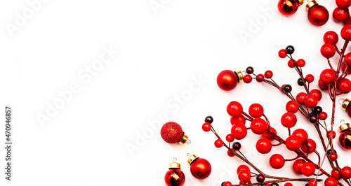 White Christmas and New Year background with red Christmas balls and berries, top view,copy spase