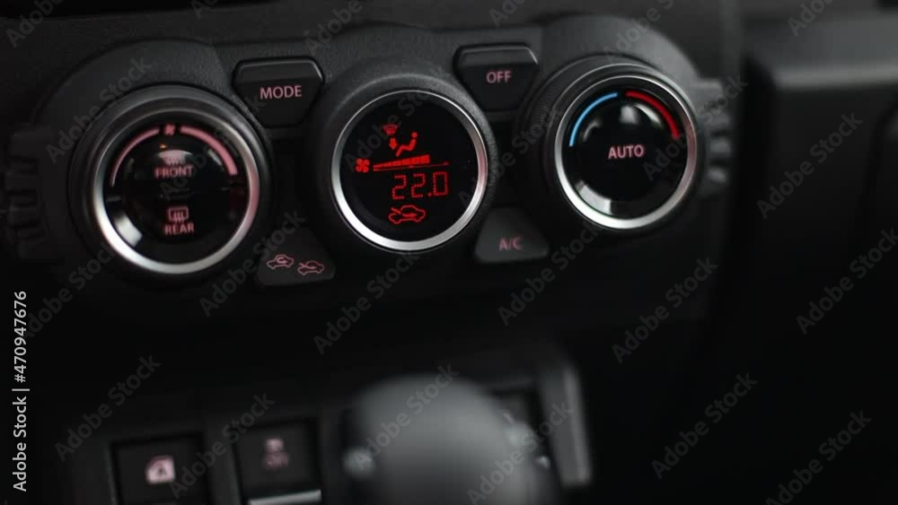Right to left movement Three round control panels for climate control in the car interior. black with red indication. Right to left movement Three round control panels for climate control in the car interior. black with red indication.