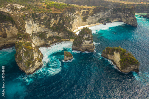Aerial shot at sea with turquoise water and rocks. Atuh beach, Nusa Penida, Bali, Indonesia.