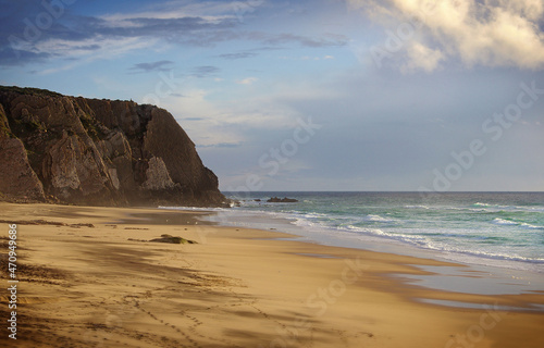 A rock formation on sandy beach