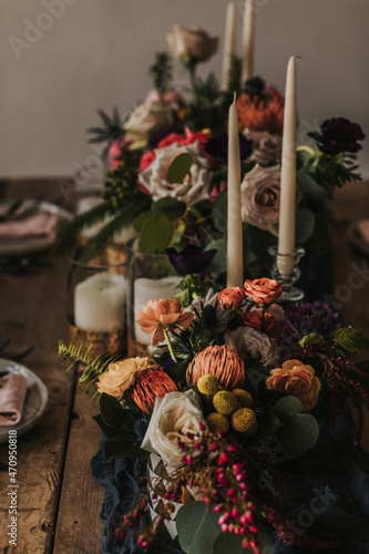 Photography wedding reception table setting decorated with flowers and candles