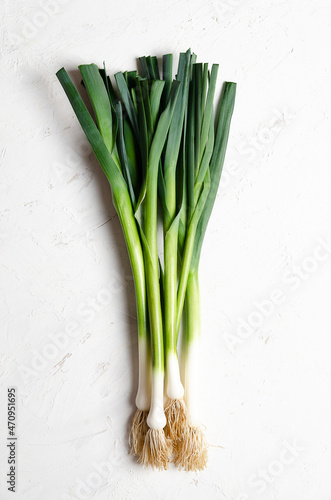 A bunch of fresh leeks on a white background. 