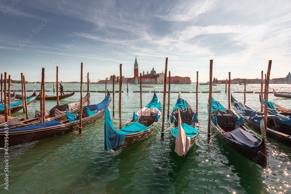 Gondolas parked at Venezia with San Giorgio Maggiore church at the back, Veneto, Italy.