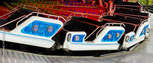 Photo of amusement park carousel carts with seats.