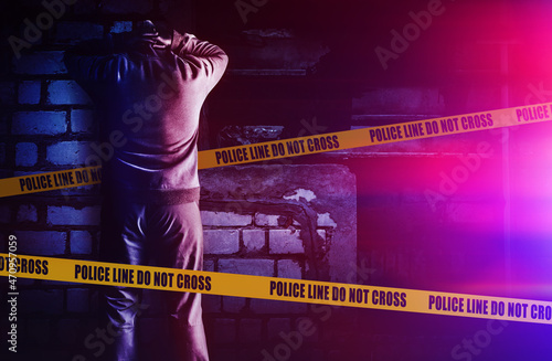 Canvas Print Photo of criminal thief man in black hoodie outfit got caught by police and leaning against the wall