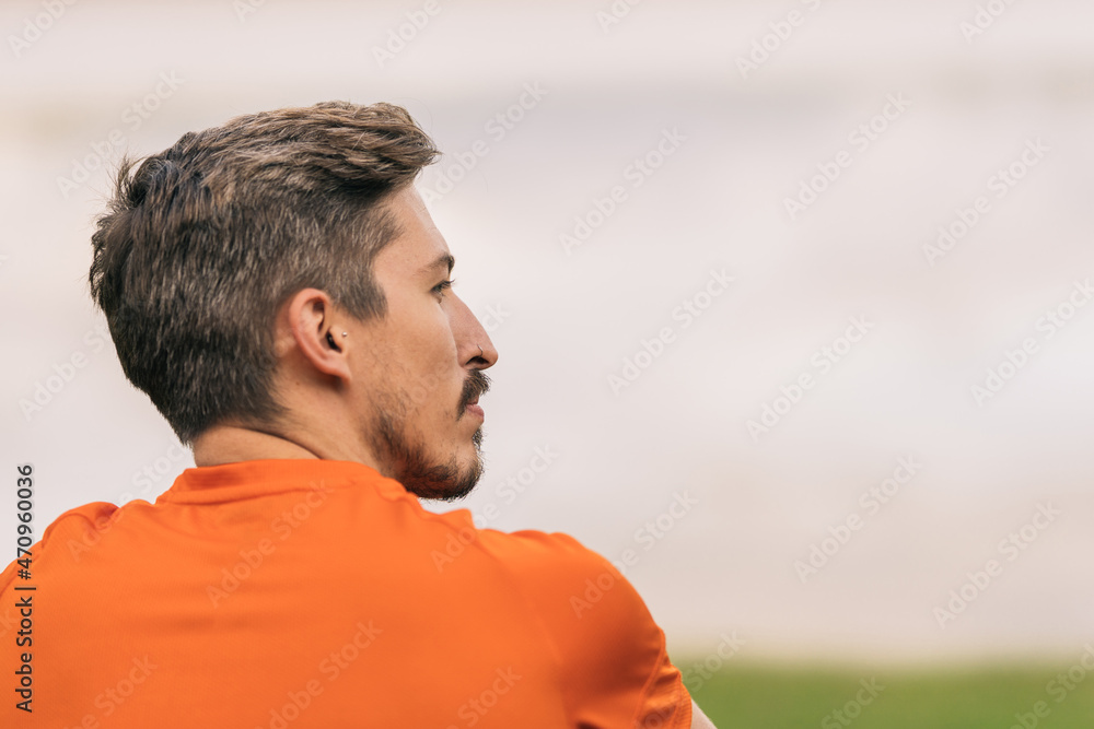 Back of a sportive man sitting on a park Back of a sportive man sitting on a park