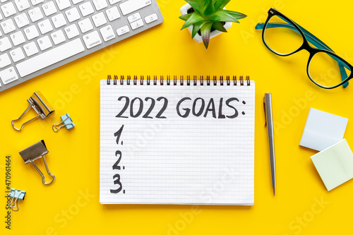 Goals 2022 - New Year plan, text in notebook. Top view, flat lay