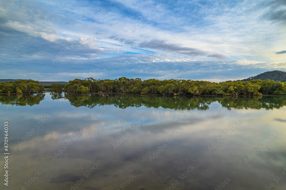 Clouds and reflections early morning waterscape