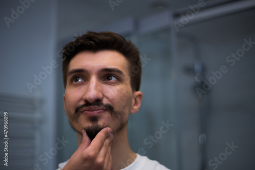 Portrait of a man with a bad heterogeneous beard