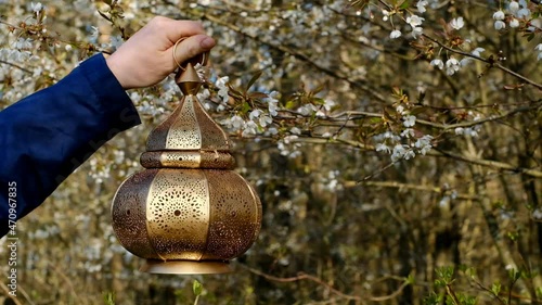 Mubarak lanternin the rays of the sun in the spring forest. Ramadan. 4k footage photo