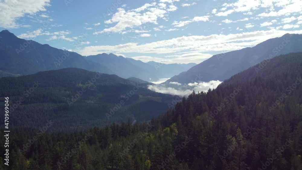 Aerial view of the surroundings of the cloud covered mountains on a sunny day Aerial view of the surroundings of the cloud covered mountains on a sunny day