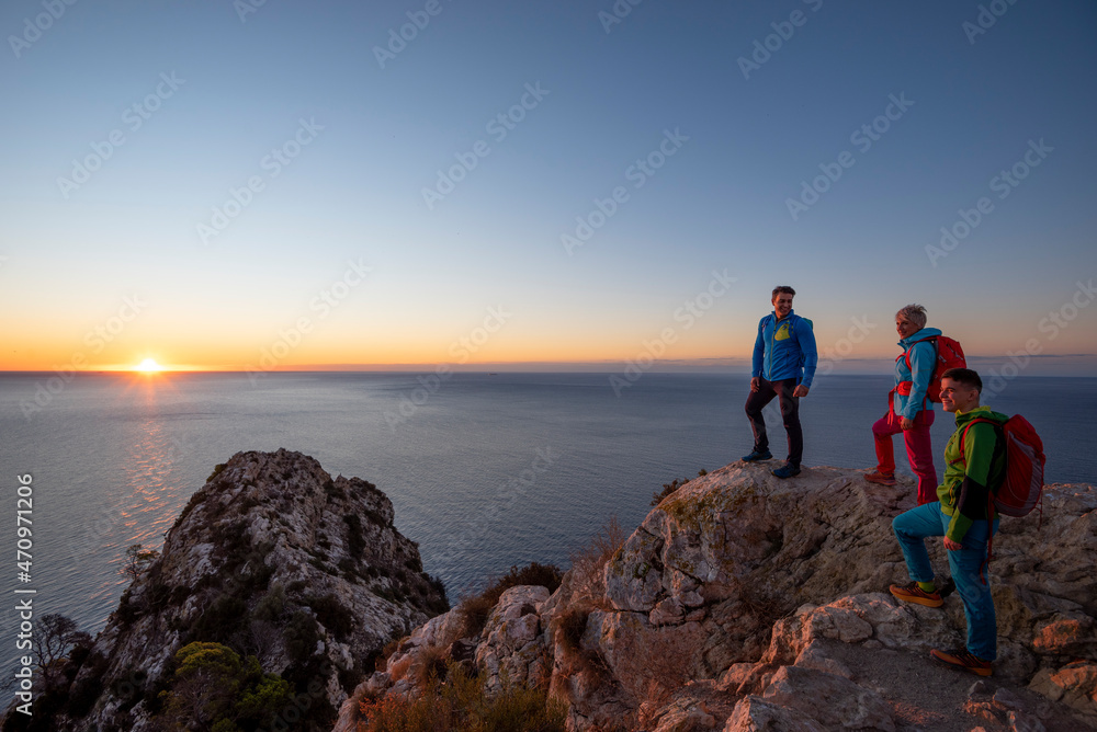 A group of friends hiking on the mountain, Calpe, Alicante, Spain A group of friends hiking on the mountain, Calpe, Alicante, Spain