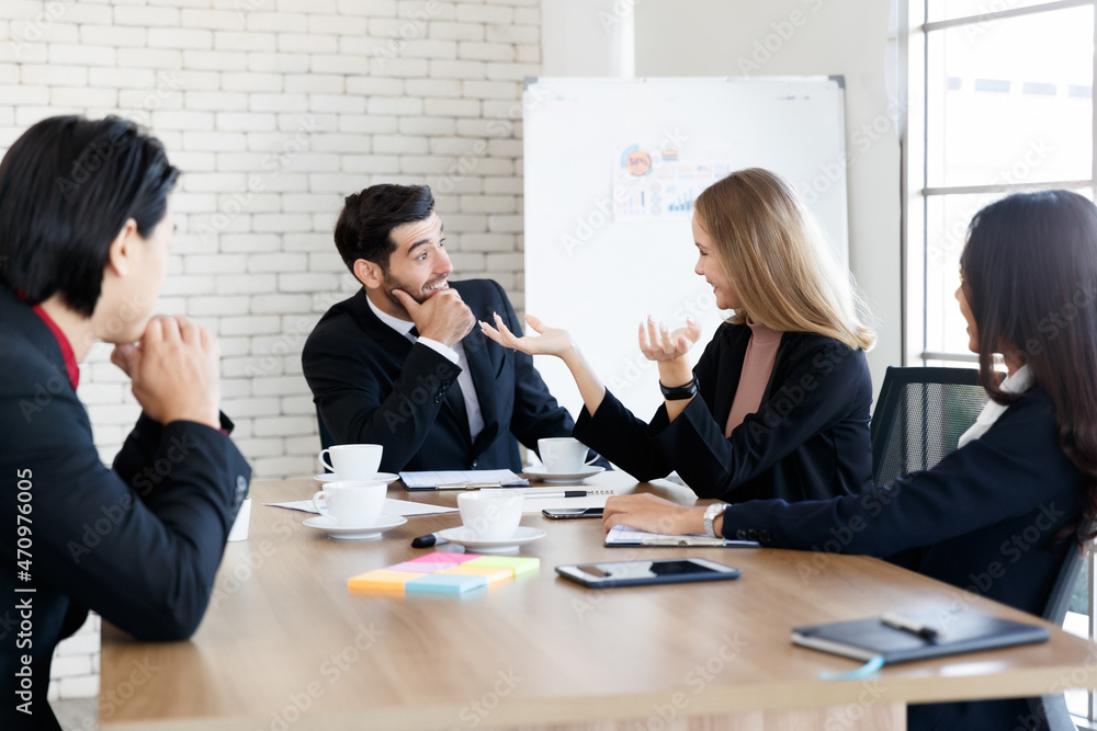 Positive multiethnic colleagues sitting in conference room Positive multiethnic colleagues sitting in conference room