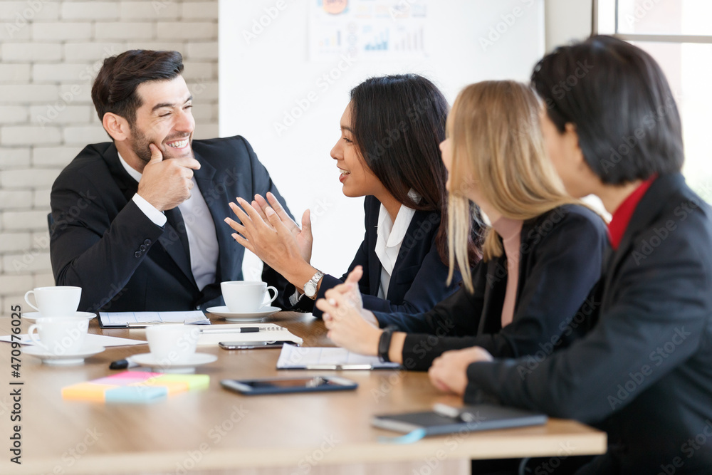 Positive multiethnic colleagues sitting in conference room Positive multiethnic colleagues sitting in conference room