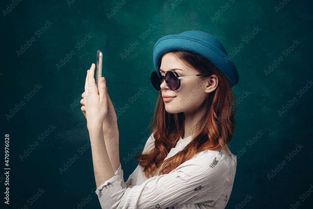 fashionable woman in blue hat with phone in hands communication technology fashionable woman in blue hat with phone in hands communication technology