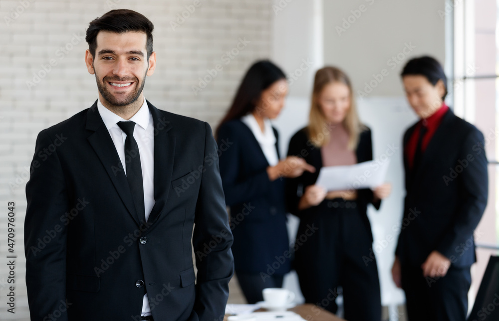 Cheerful man near multiethnic colleagues Cheerful man near multiethnic colleagues