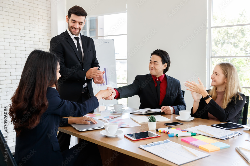 Faceless man shaking hand of positive colleague Faceless man shaking hand of positive colleague