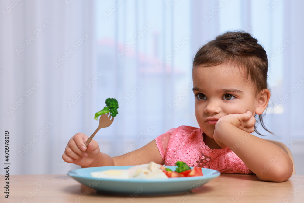 Cute little girl refusing to eat her breakfast at home Cute little girl refusing to eat her breakfast at home
