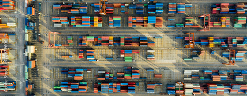 Aerial Top view. Container ship in pier with crane bridge carries out export and import business in the open sea. Logistics and transportation. Banner panorama