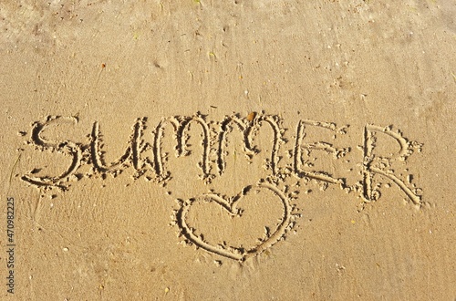 inscription on the beach. the word summer is written on the sandy seashore. travel tourism concept