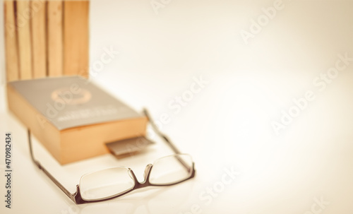 Wallpaper Mural read glasses selective focus on blur Bookmark in old book on white background copy space Torontodigital.ca