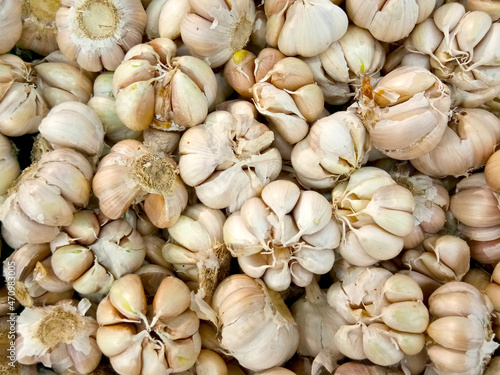 A close-up photo stack of garlic bulb. The photo was taken on the fresh food ingredient market