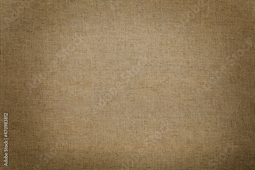 Texture of natural burlap fabric as background, top view. Vignette effect