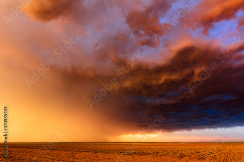 Sunset sky and storm clouds over a field