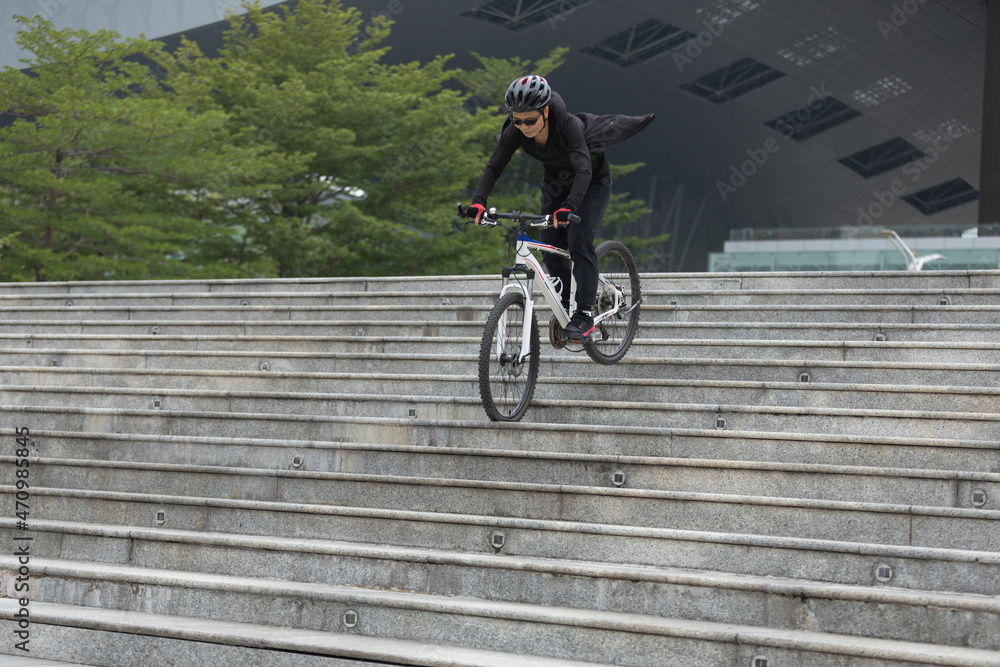 Woman free rider riding bike going down 