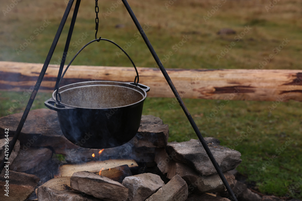 Cooking food on campfire outdoors. Camping season Cooking food on campfire outdoors. Camping season