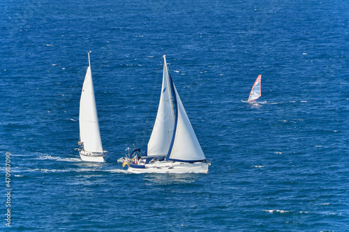 Sailboats and windsurfing in the bay of Santander, Cantabria. Spain.