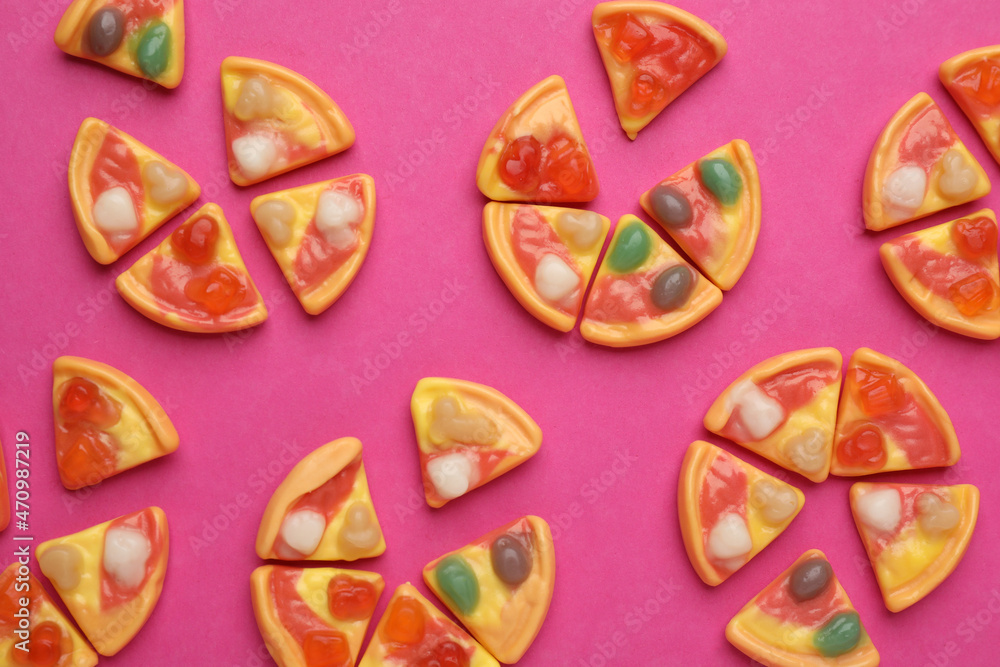 Tasty jelly candies in shape of pizza on pink background, flat lay