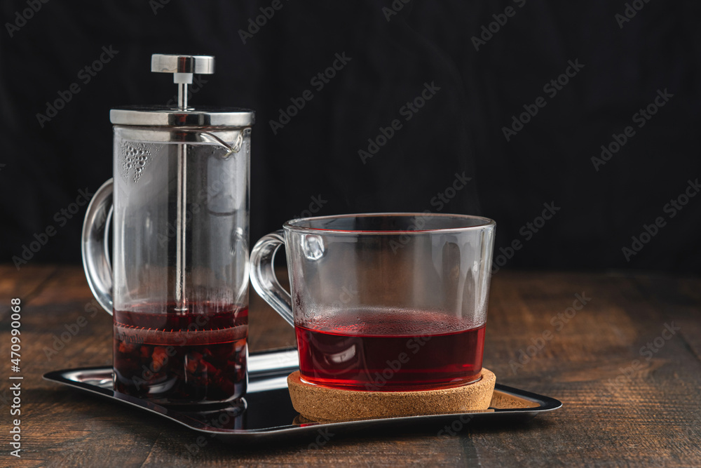 Hot winter tea served with a french press on a wooden floor Hot winter tea served with a french press on a wooden floor