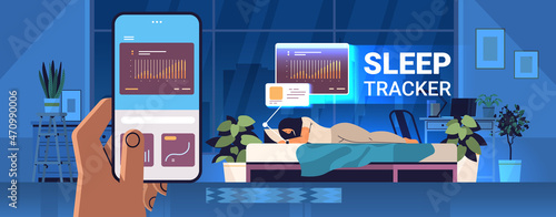 woman sleeping in bed with electronic smart watch app tracker on hand quality and quantity sleep control concept