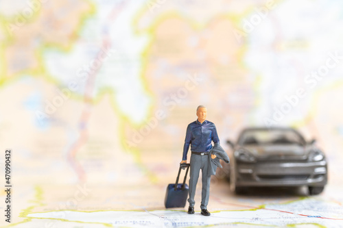 Miniature people Businessman with luggage walking on The map , Travel and Adventure concepts