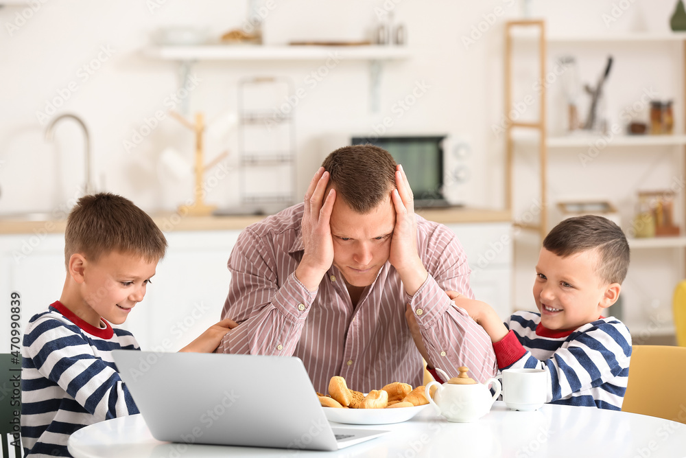 Tired father with his little children spending time together at home Tired father with his little children spending time together at home