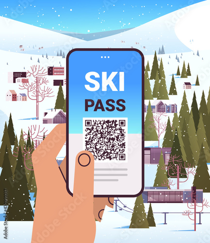human hand using ski pass application on smartphone screen winter vacation concept snowy mountains landscape