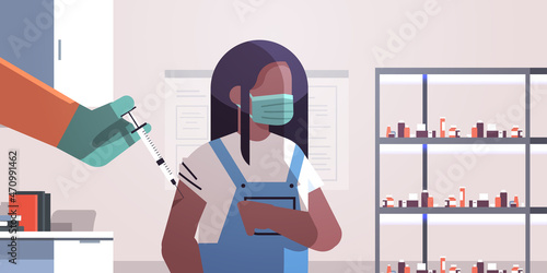 doctor hand vaccinating african american girl patient in medical mask fight against coronavirus vaccine development