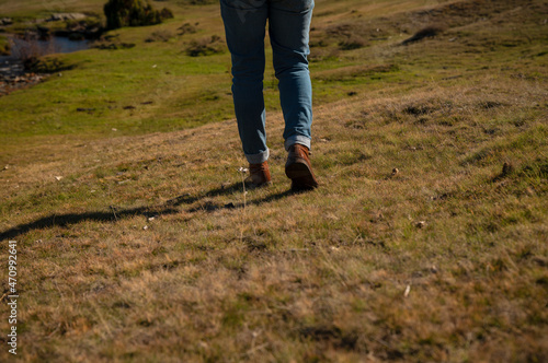Adult man legs walking in countryside with sunlight and shadow, in Guadalajara, Spain