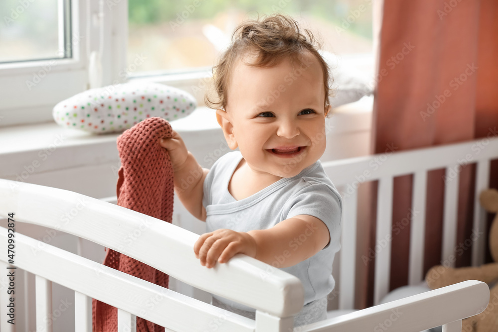 Cute little baby with plaid in crib Cute little baby with plaid in crib