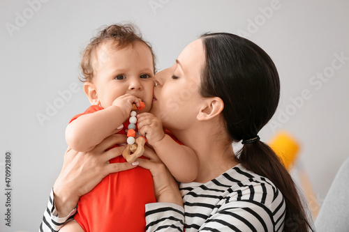 Young mother kissing her li...