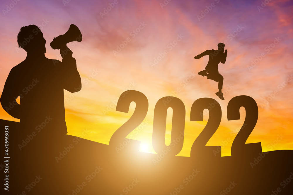 Happy New Year Numbers 2022, Silhouette a man handsome wearing shouting with megaphone and man jumping feels happy moving morning over the horizon background, Health and Happy new year concept. Happy New Year Numbers 2022, Silhouette a man handsome wearing shouting with megaphone and man jumping feels happy moving morning over the horizon background, Health and Happy new year concept.