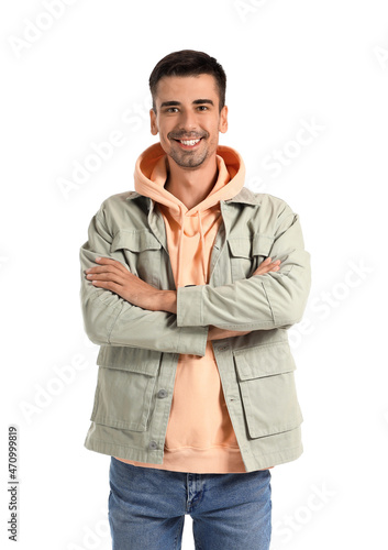 Young man in stylish hoodie and jacket on white background