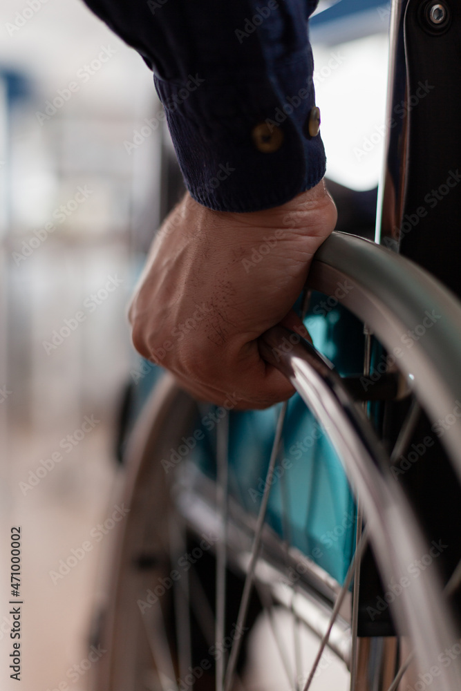 Φωτογραφία Closeup of disabled paralyzed businessman hands in wheelchair working at management strategy in startup business corporate office
